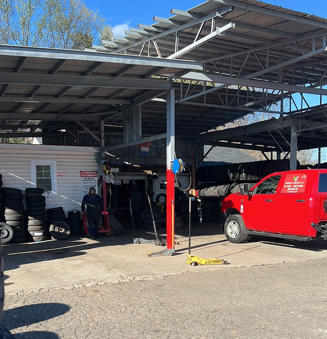Our covered service bays with a crew member and tire stacks
